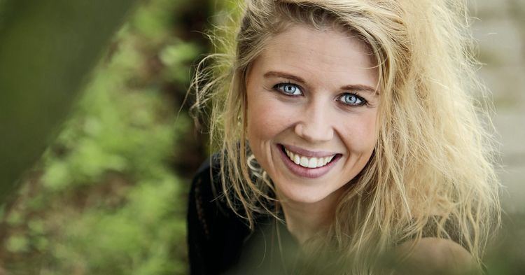 Salka Sól Eyfeld smiling while wearing a black blouse