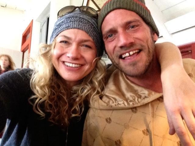 Sally Taylor with a happy face, wearing a bonnet with sunglasses on it, and a black shirt together with Ben Taylor wearing a bonnet and brown jacket.