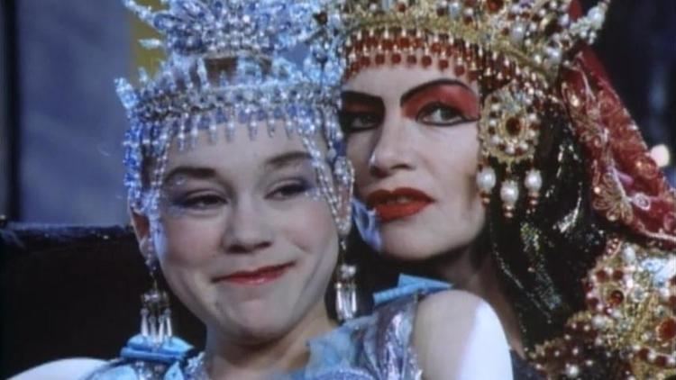 Imogen Millais-Scott smiling while Glenda Jackson whispering to her in a scene from the 1988 film, Salome's Last Dance