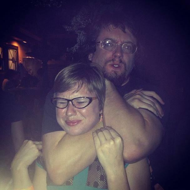 Sam Hyde choking the woman with an angry face, mustache, and beard. 