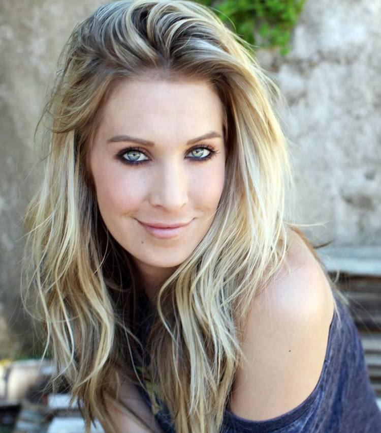 Samantha Schacher smiling and wearing blue blouse