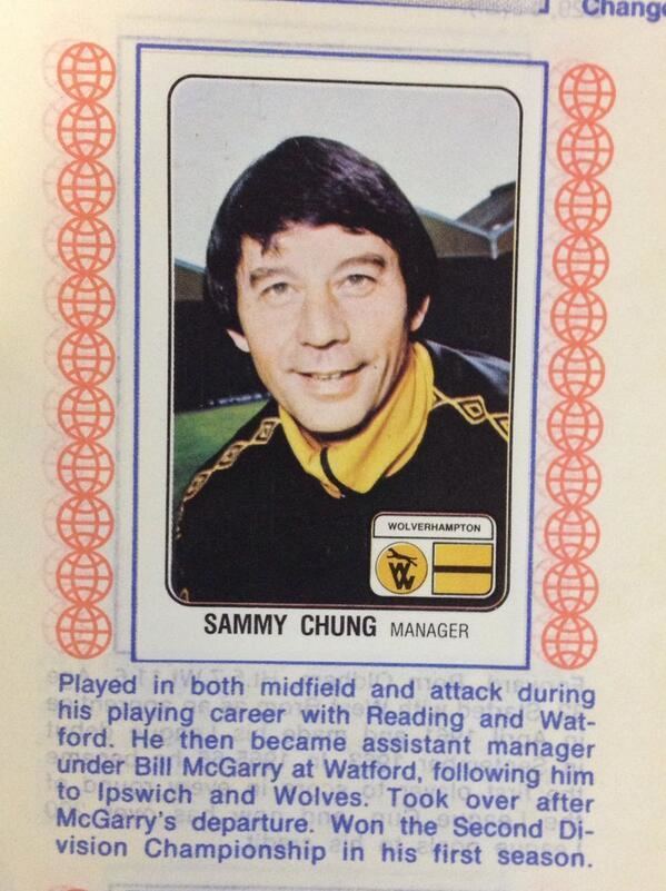 A poster of Wolves Manager Sammy Chung smiling and wearing a black and yellow uniform.