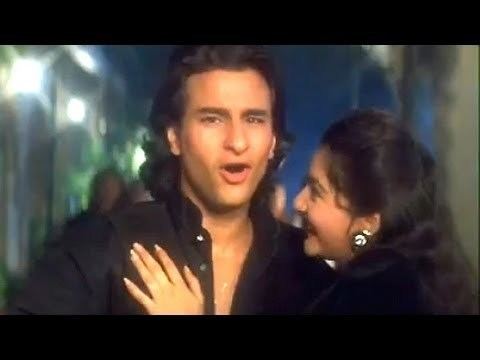 In the movie scene of Sanam Teri Kasam (film) 2009, Saif Ali Khan(left) is singing, mouth half open, has black hair wearing a black unbuttoned long sleeve polo, Pooja Bhatt(right) is smiling, looking at Saif face, mouth half open, with her left hand on the right shoulder of Saif, has black hair wearing a black earring and black shirt.