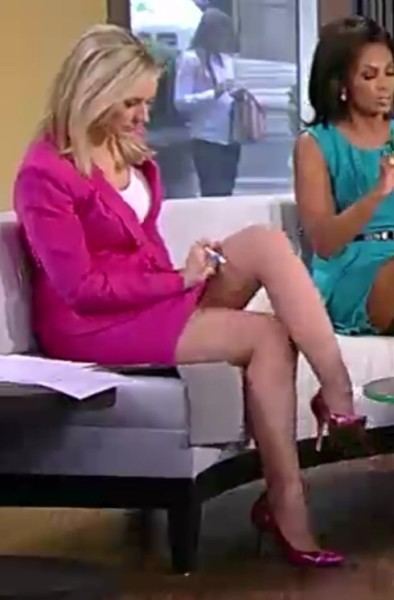 Sandra Smith in her pink outfit while crossing her legs