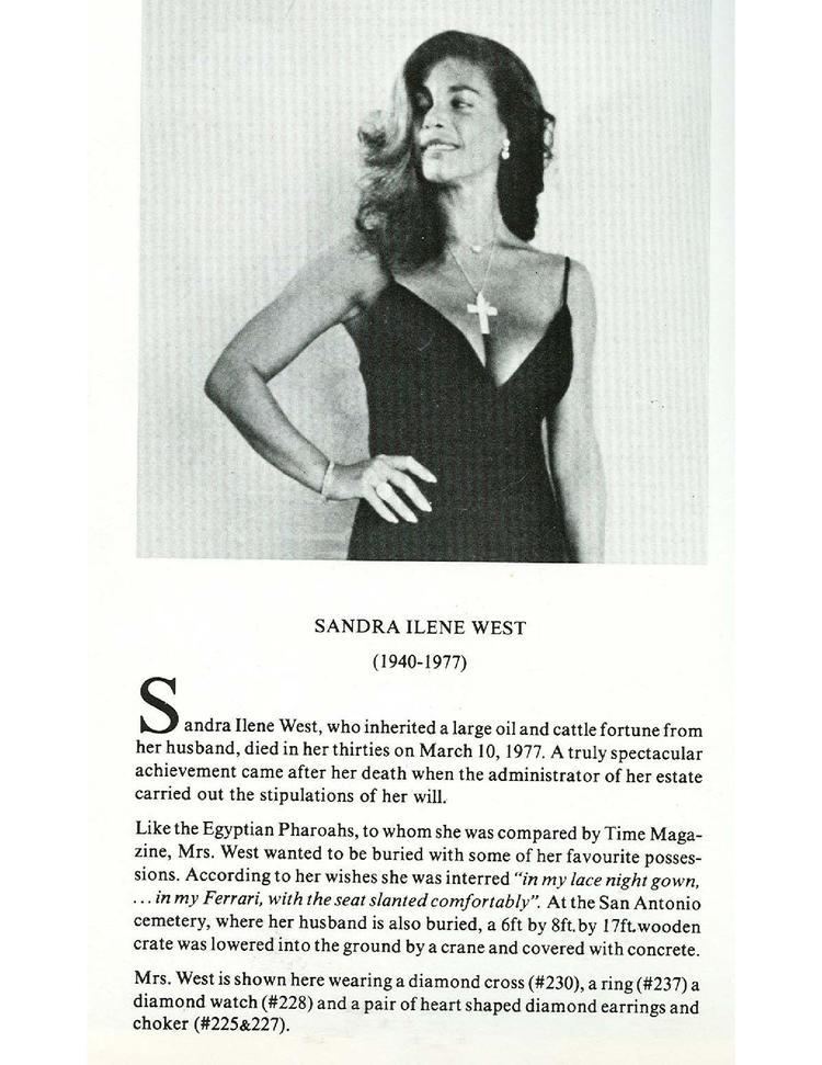 Sandra West on her will posing with her hand in her waist and wearing a sleeveless black dress and a rosary.