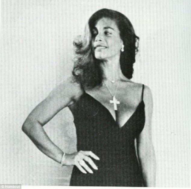 Sandra West posing with her hand in her waist and wearing a sleeveless black dress and a rosary.