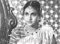 Santha Kumari wearing a headdress, some pieces of jewelry, and a dress