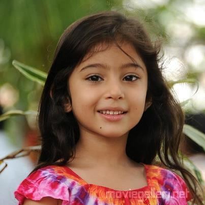 Sara Arjun smiling with her hair down while wearing a colorful blouse