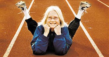 Smiling Sara Wedlund laying down in Running Track