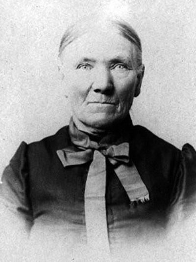 Sarah E. Goode with a serious face with her clean hairstyle wearing a ribbon and a blouse.