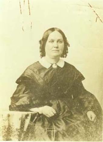 Sarah Ann Osborne Fuller with a serious face and wearing a black dress with a white collar.