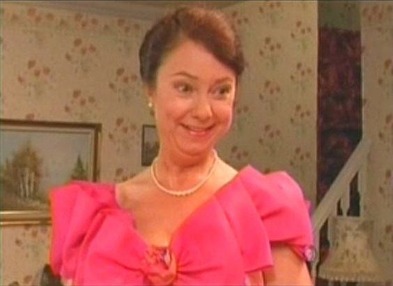 Scene of Sarah Thomas as Glenda smiling and wearing a pink dress in the series "Last of the Summer Wine" (1973–2010)