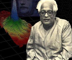 Satyendra Nath Bose is serious, and has white hair, on left is a presentation of Bose-Einstein Condensate. Graph of the density of low-velocity rubidium atoms forming a Bose-Einstein Condensate (BEC), he is wearing eyeglasses and a white suit. Behind is Einstein’s half face visible, he is serious.