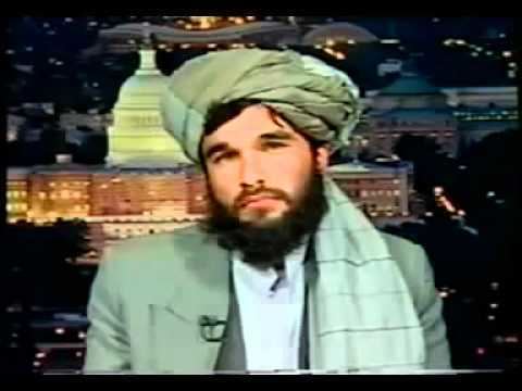 Sayed Rahmatullah Hashemi with mustache and beard while wearing a green turban, green coat and white long sleeves