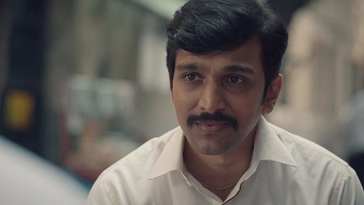 Pratik Gandi as Harshad Mehta smiling with a mustache and wearing a white shirt