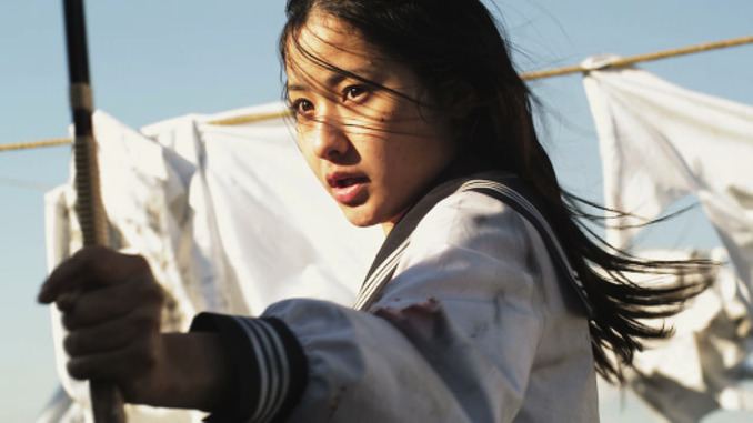 In the movie scene SchoolGirl Apocalypse 2011, Higarino with a fierce look, has long black hair, holding a sword, wearing a white seifuku school uniform with a black marine collar.