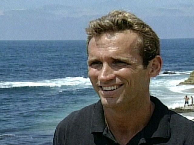 Scott Helvenston smiling while at the beach and wearing a black shirt