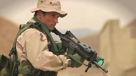 Scott Helvenston carrying a firearms while wearing a military uniform