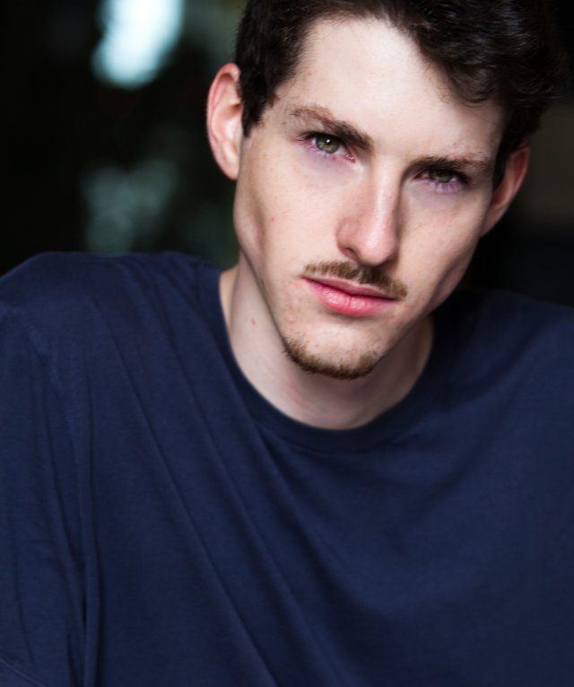 Sean Flynn (actor) wearing a dark blue shirt