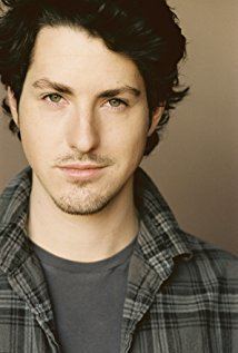 Sean Flynn (actor) wearing a gray checkered shirt