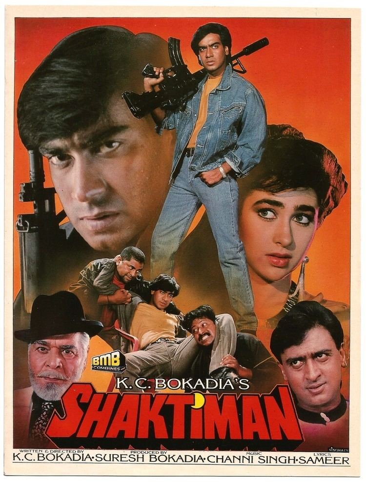 Ajay Devgn holding a rifle with Karisma Kapoor, Mukesh Khanna, and Ajit Khan in the movie poster of the 1993 film, Shaktiman