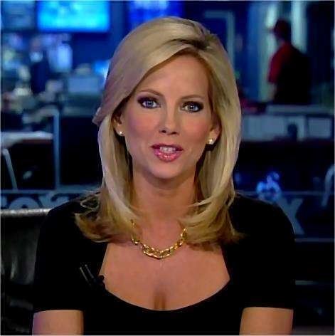 Shannon Bream speaking with blonde shoulder-length hair while wearing a necklace, earrings, and a wireless mic on her black blouse with U-shaped neckline that exposes her cleavage.