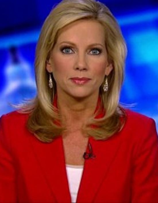 Shannon Bream with a tight-lipped smile and blonde shoulder-length hair while wearing earrings and a wireless mic on her red coat and a white top underneath.