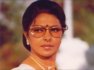Young Sharada wearing eyeglasses, nose-jewel, necklace and earrings