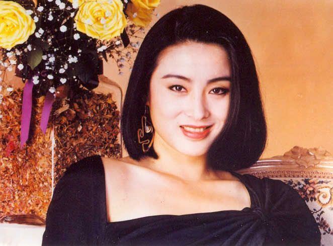 Smiling Sharla Cheung wearing a black dress