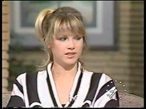 Shelley Preston with an annoyed face, with blonde hair, and wearing a black and white top.
