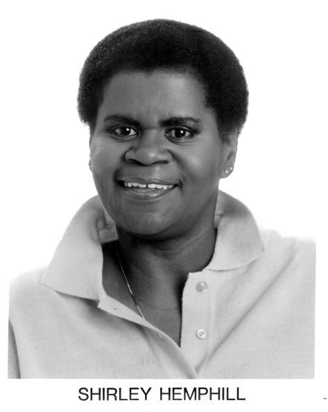 Shirley Hemphill wearing earrings, a necklace, and a polo shirt.