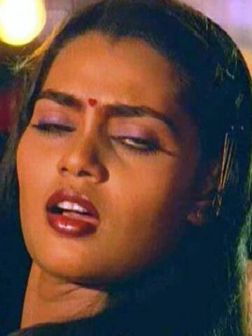 Silk Smitha with her eyes closed and mouth open