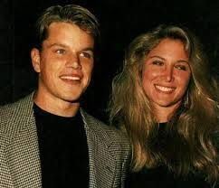 Skylar Satenstein smiling and wearing a black blouse while Matt Damon wearing a checkered coat and black t-shirt