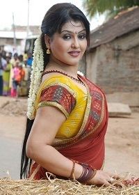 Sona Heiden smiling while wearing a red and yellow traditional Indian dress and some pieces of jewelry