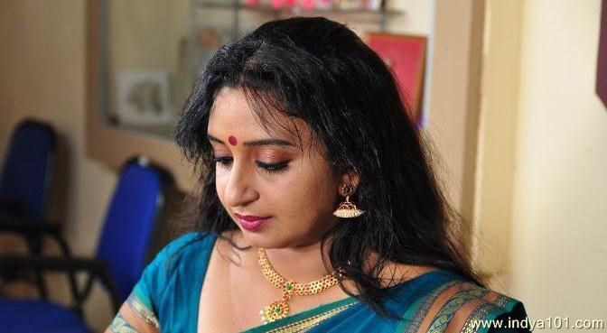 Sona Nair with messy hair, wearing earrings, a necklace, and Indian traditional clothing.