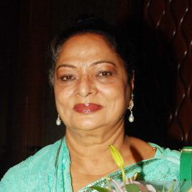 Sonia Sahni smiling and wearing a green dress.