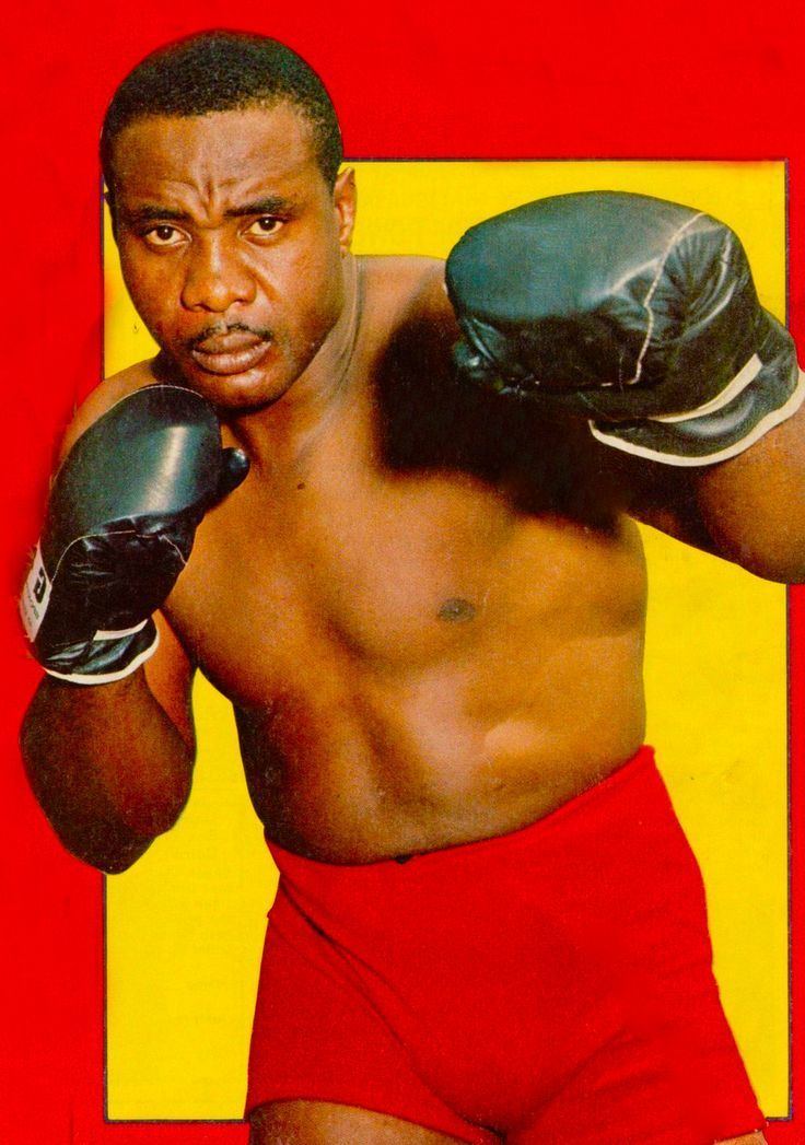Sonny Liston wearing boxing gloves and red short