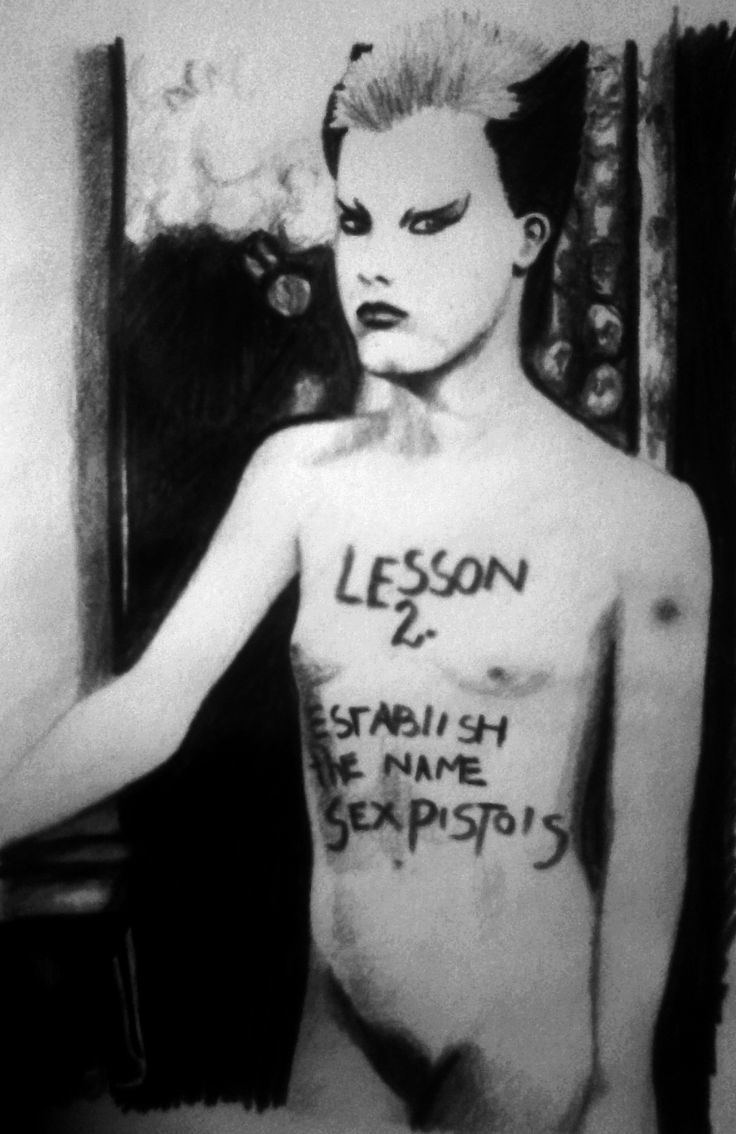 Soo Catwoman is serious while standing, has a mole on her left arm, spiky black and white hair, fierce makeup and written words in her body Lesson 2. Estabish the name sexpistols, Pubichair is seen naked.