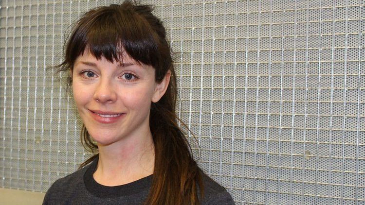 Sophia Di Martino smiling and wearing black shirt