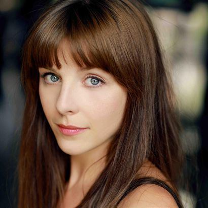 Sophia Di Martino with brown hair and bangs