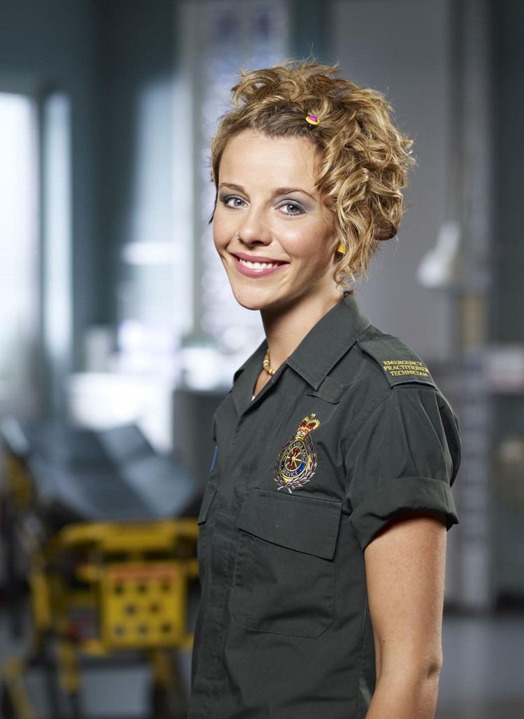 Sophia Di Martino smiling and wearing an ambulance technician uniform