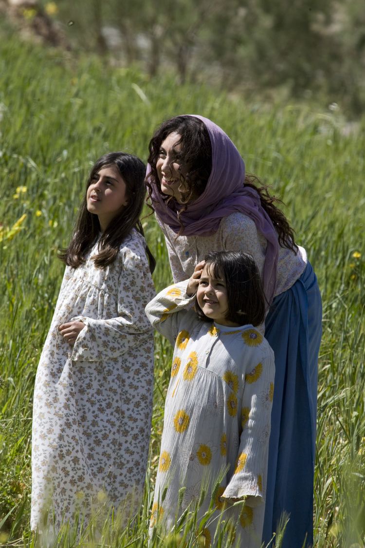 Mozhan Marnò and Noor Taher smiling while looking afar in a movie scene from The Stoning of Soraya M. (2008 film)