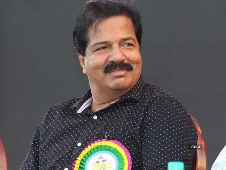 Sreekandan Nair smiling while wearing a black and white polka dot long sleeves