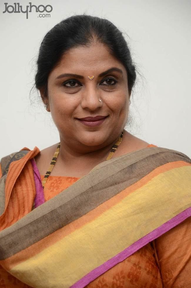 Sripriya wearing an orange dress at Press Meet