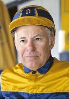 Stanley Dancer wearing blue and yellow outfit and cap