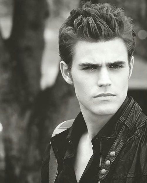 Stefan Salvatore looking something seriously, spiked hairs and wearing a sliveless jacket