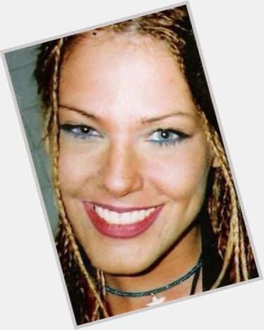 Stephanie Opal Weinstein with a smiling face, with blonde braid hair, and wearing a choker with a star pendant.