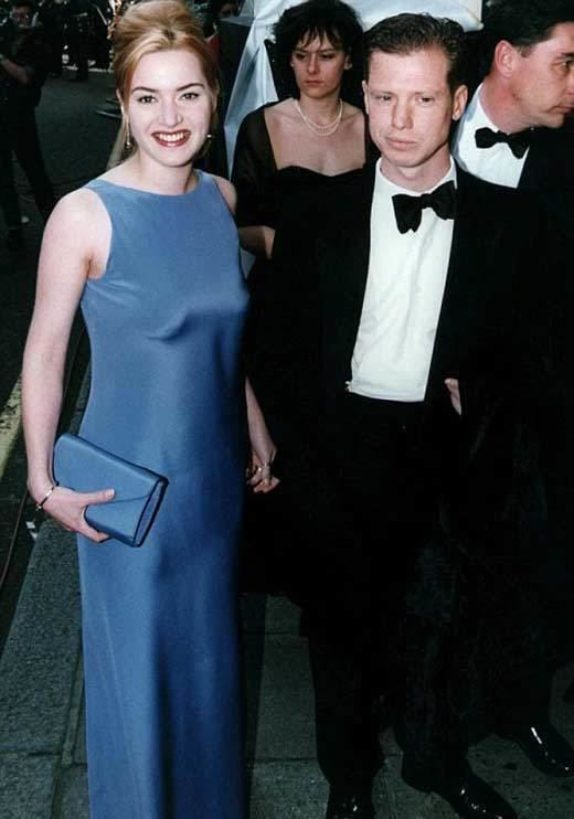 Stephen Tredre wearing a formal attire with Kate Winslet in a blue gown
