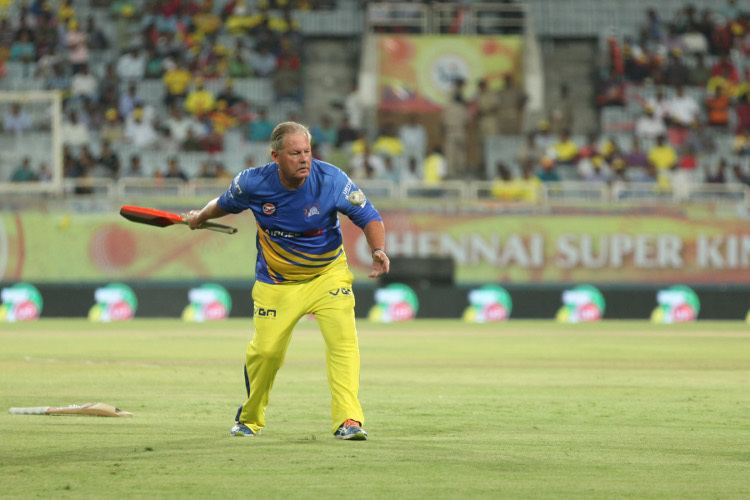 Steve Rixon is batting inside the field wearing shoes, a blue jersey, and yellow pants