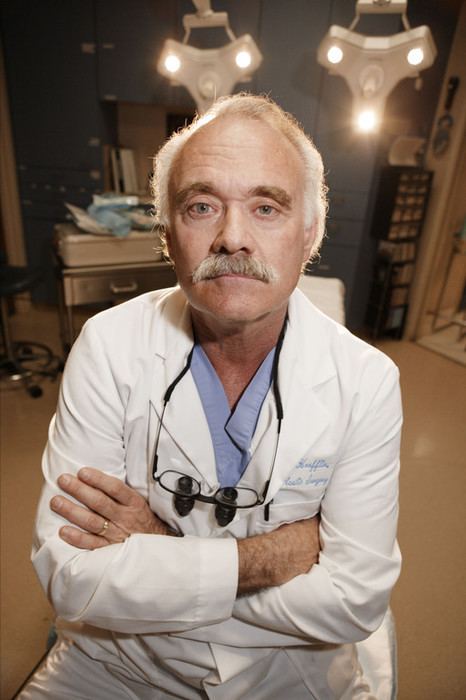 Steven Hoefflin while his arms crossed and wearing lab gown